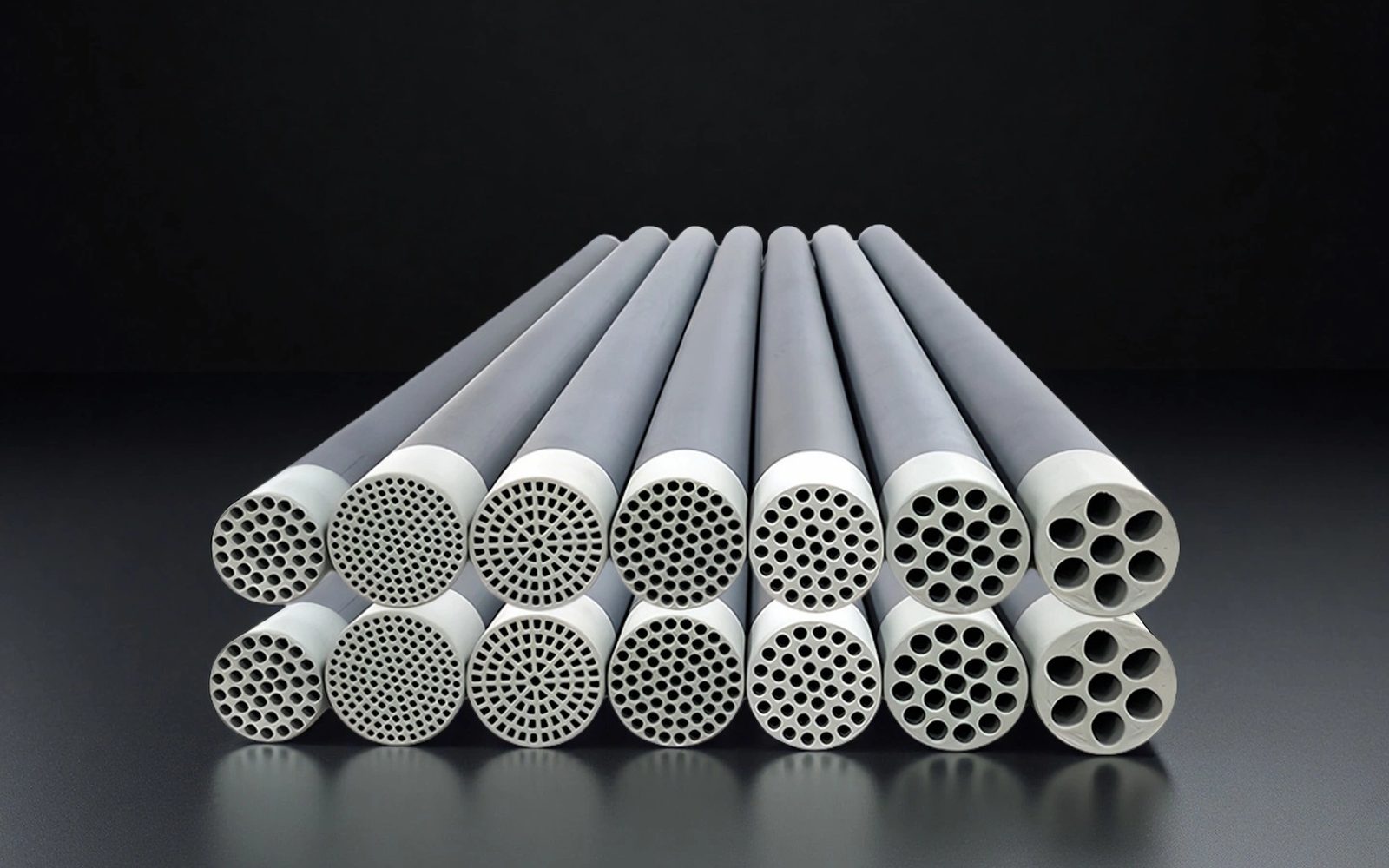Silicon carbide multi-channel tubular ceramic elements. Dark ceramic bodies, white channel ends.